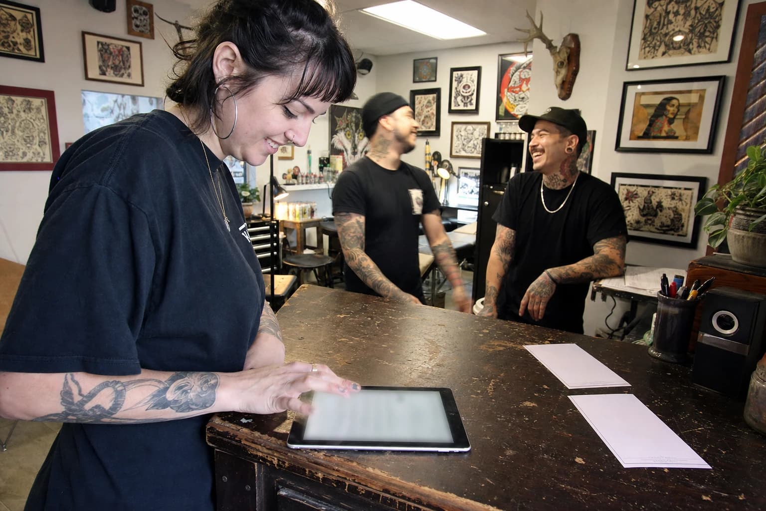 Client filling out an intake form on a studio tablet